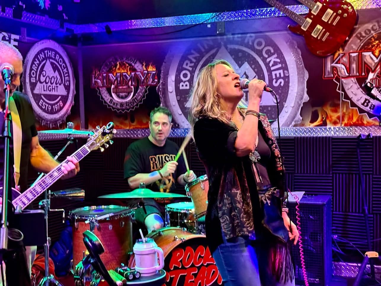 Rock Steady singer performing live under colorful lights